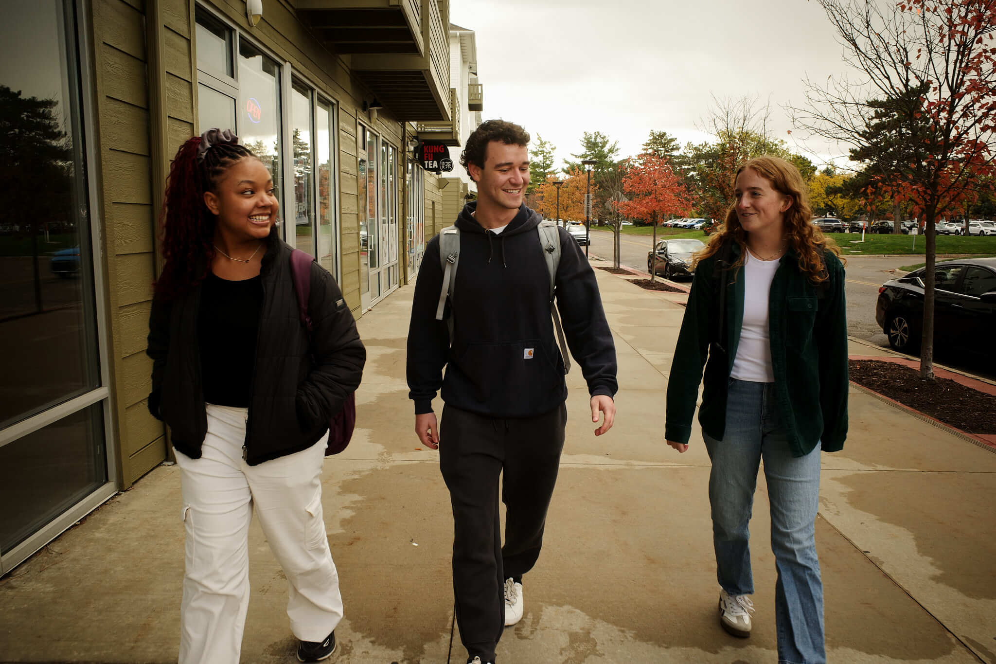 three students walking downtown